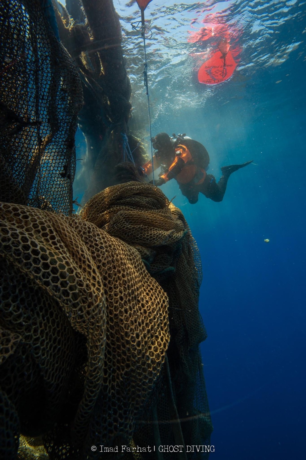 Imad Farhat Ghost Diving conservation diver retrieving abandoned fishing net underwater
