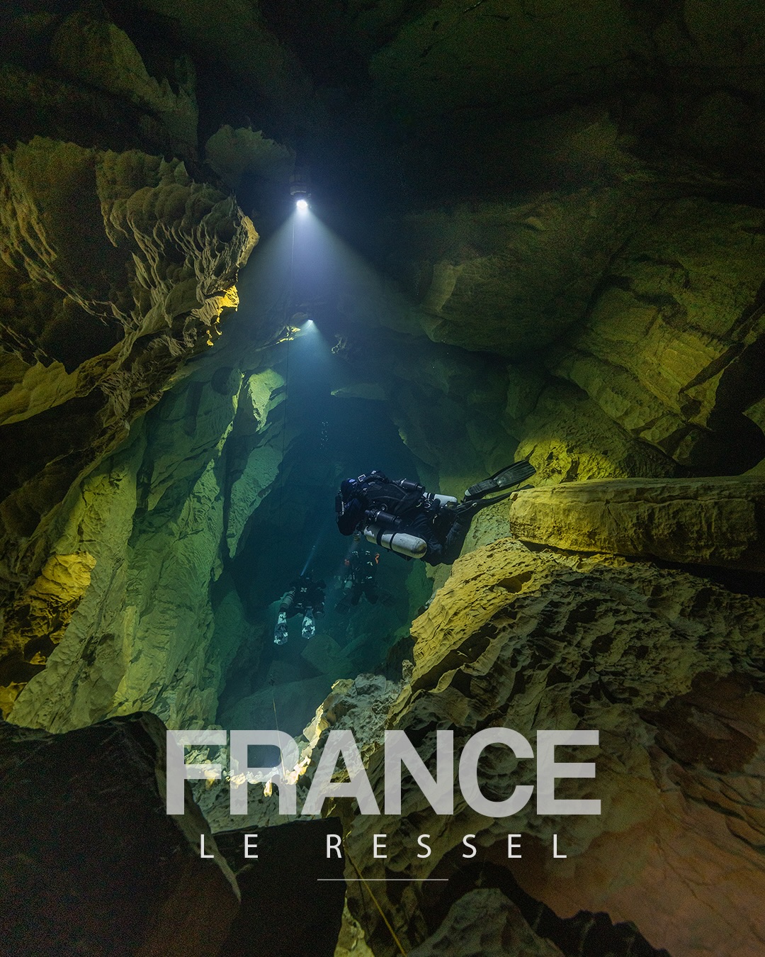 Imad Farhat GUE cave diver descending through Le Ressel cave shaft, Lot Valley France