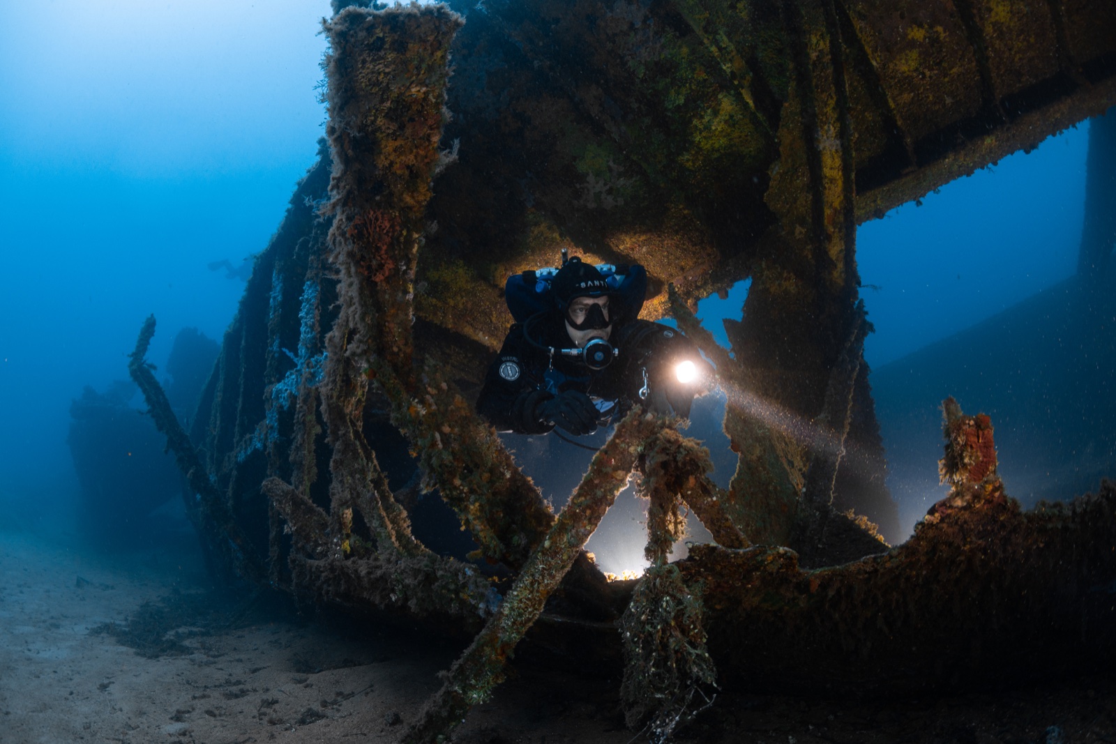 Imad Farhat GUE diver inside Mediterranean wreck with primary light beam